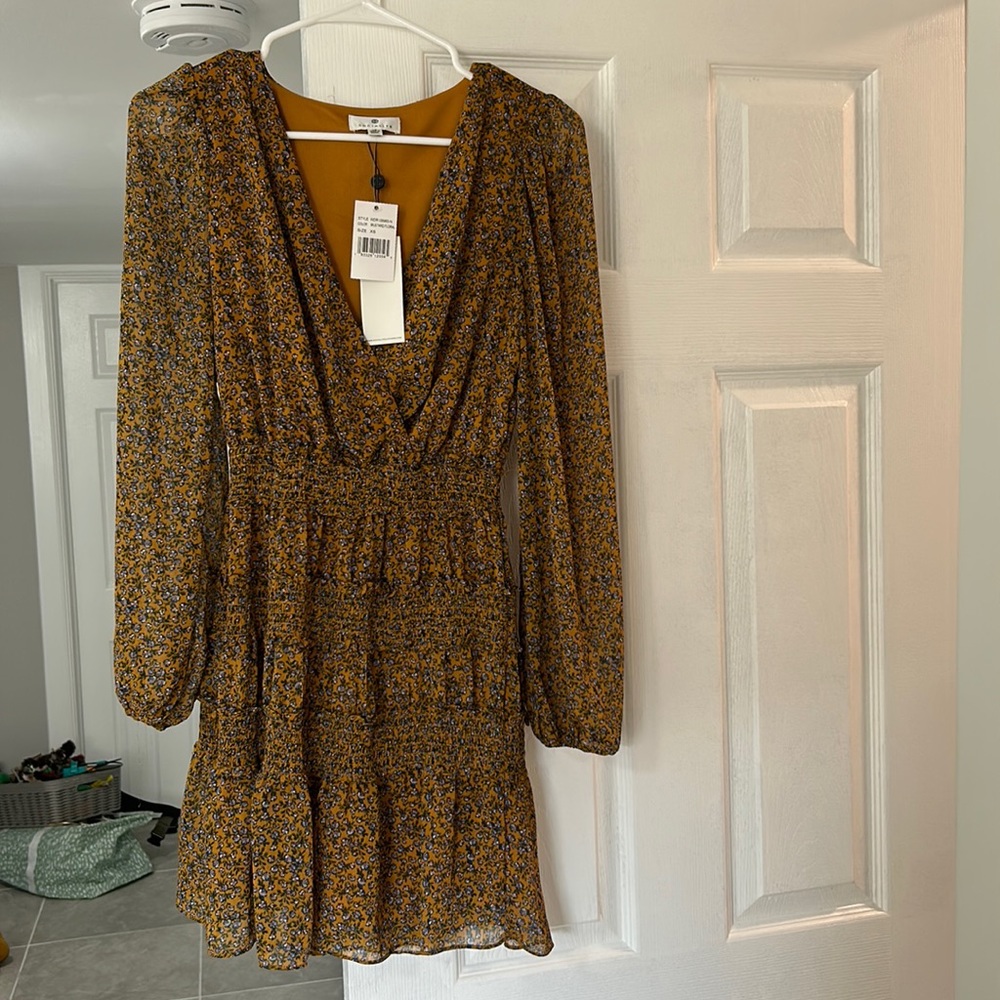 Socialite dress. Never worn. Size XS. Mustard color with floral details.